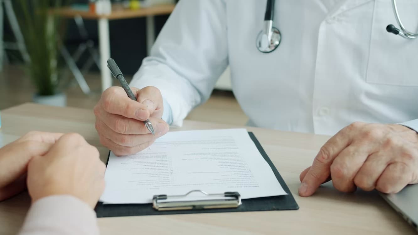 Nurse writing clear, objective nursing documentation notes on a patient chart